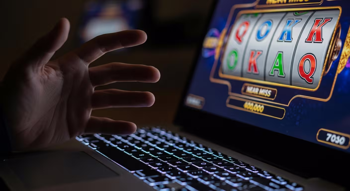 Player staring intensely at nearly matching symbols on a glowing slot machine screen
